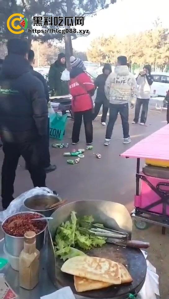 山东日照航海工程职业学院门口卖淀粉肠的摊主惨了!白衣男当街掀摊,城管还是社会哥?